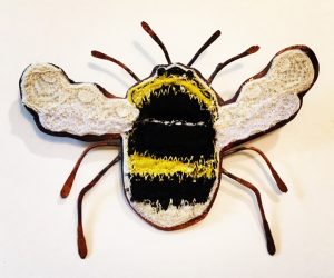 Small embroidered bee with a copper body.